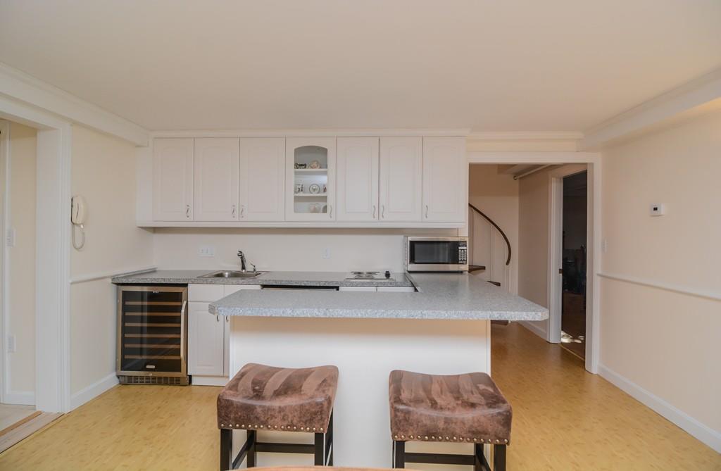 7 Benjamin Road Lexington, MA 02421 - Photo 39 of 42 a kitchen with stainless steel appliances granite countertop a sink refrigerator and cabinets