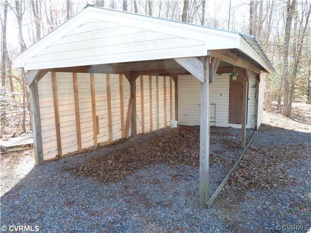 9212 Colemans Lake Road Ford, VA 23850 - Photo 4 of 10 a backyard of a house with a large tree