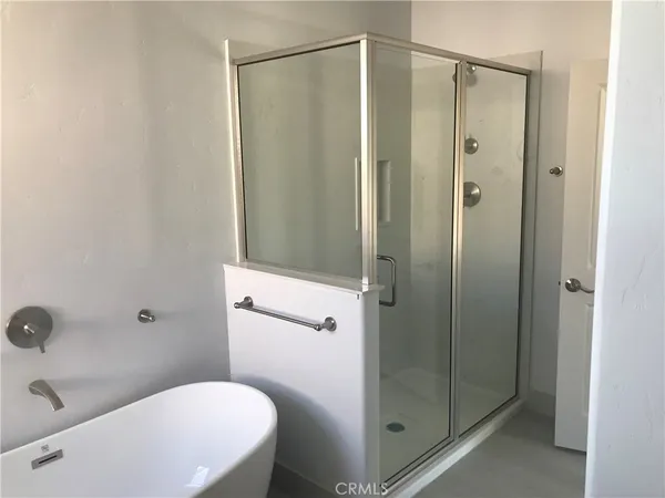 a bathroom with a shower a toilet and sink