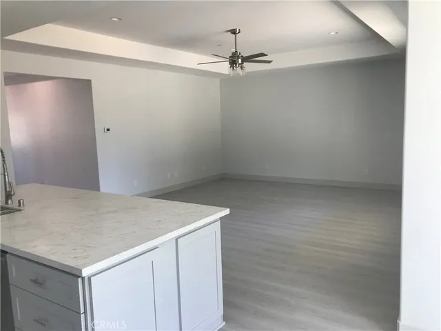 a bathroom with a granite countertop toilet a sink and mirror