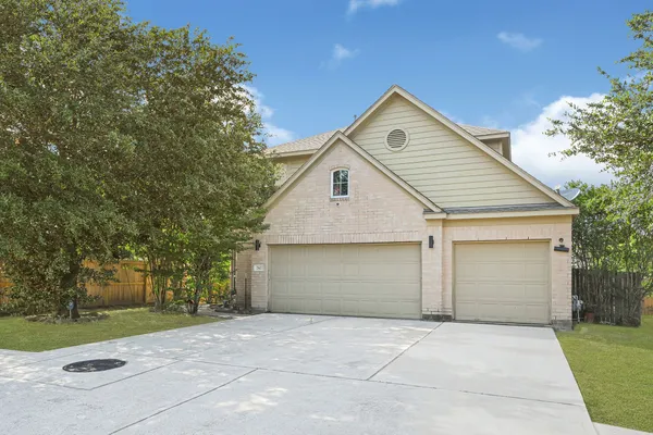 a view of backyard of house and garage
