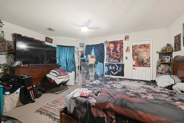a bedroom with bed and a flat screen tv