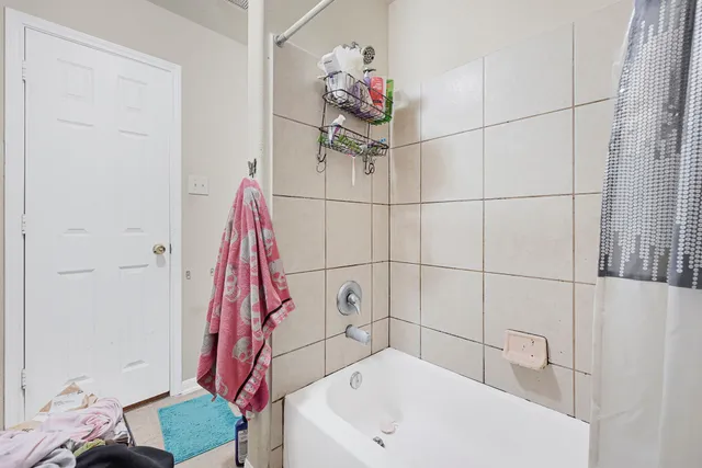 a bathroom with a bathtub and a shower
