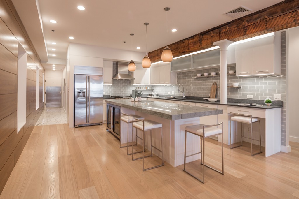 a kitchen with stainless steel appliances granite countertop a stove a sink and a refrigerator