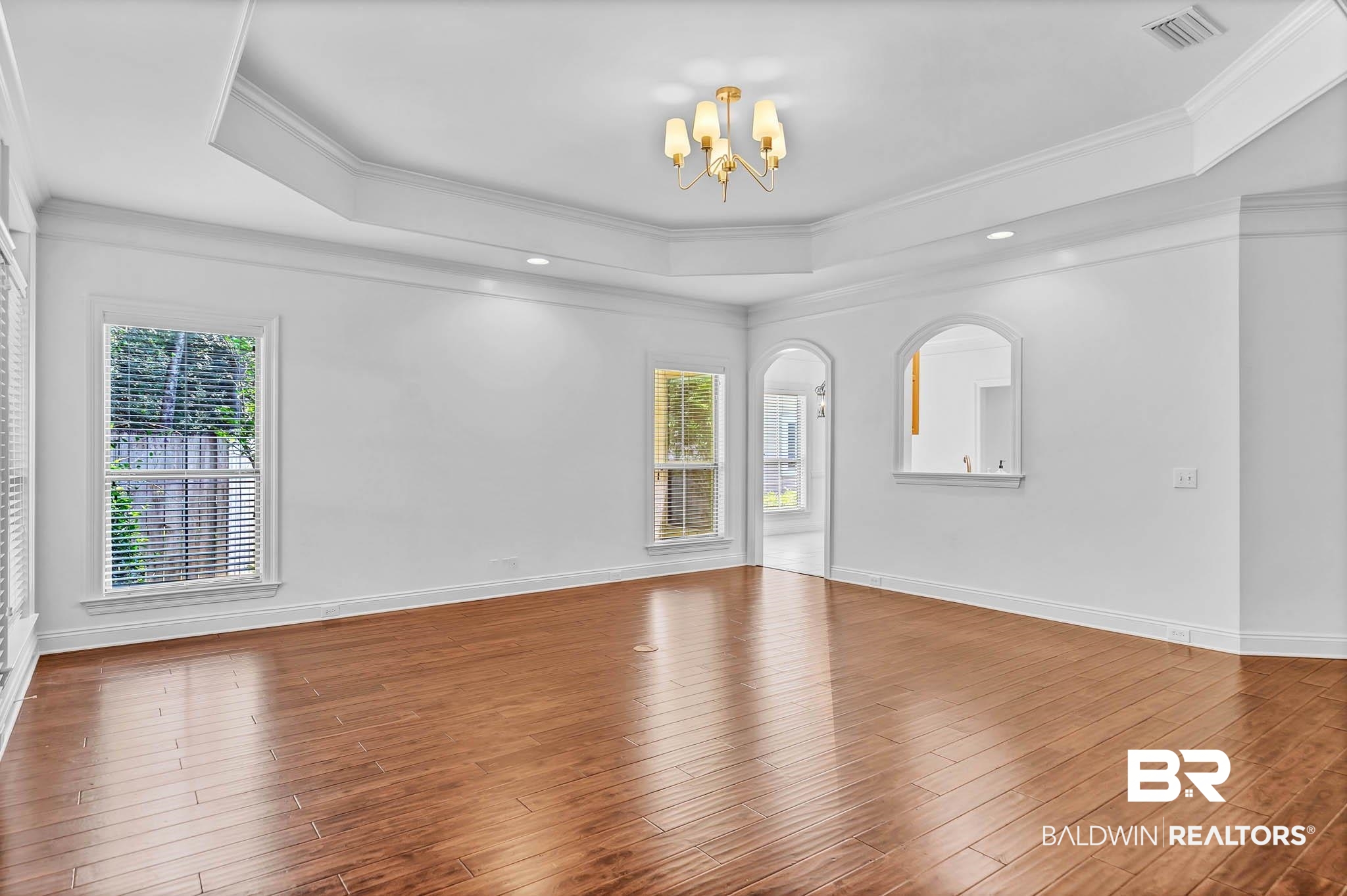 105 Cedar Pointe Fairhope, AL 36532 - Photo 8 of 38 Spare room featuring a raised ceiling, a chandelier, wood finished floors, ornamental molding, and recessed lighting
