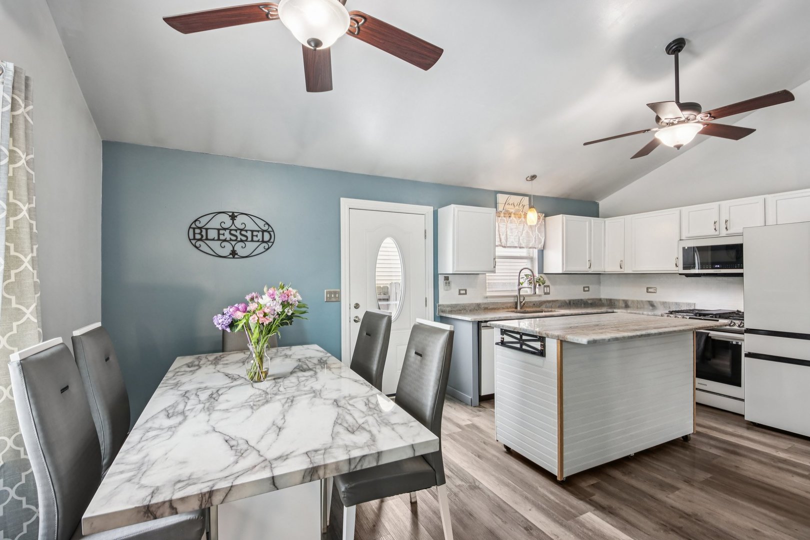 410 Riverside Drive Lakemoor, IL 60051 - Photo 6 of 21 a kitchen with stainless steel appliances granite countertop a stove top oven a sink dishwasher and white cabinets with wooden floor