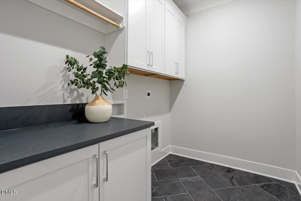 811 Maple Berry Lane, Unit 101 Raleigh, NC 27607 - Photo 29 of 45 a view of a white cabinets and potted plant on a counter
