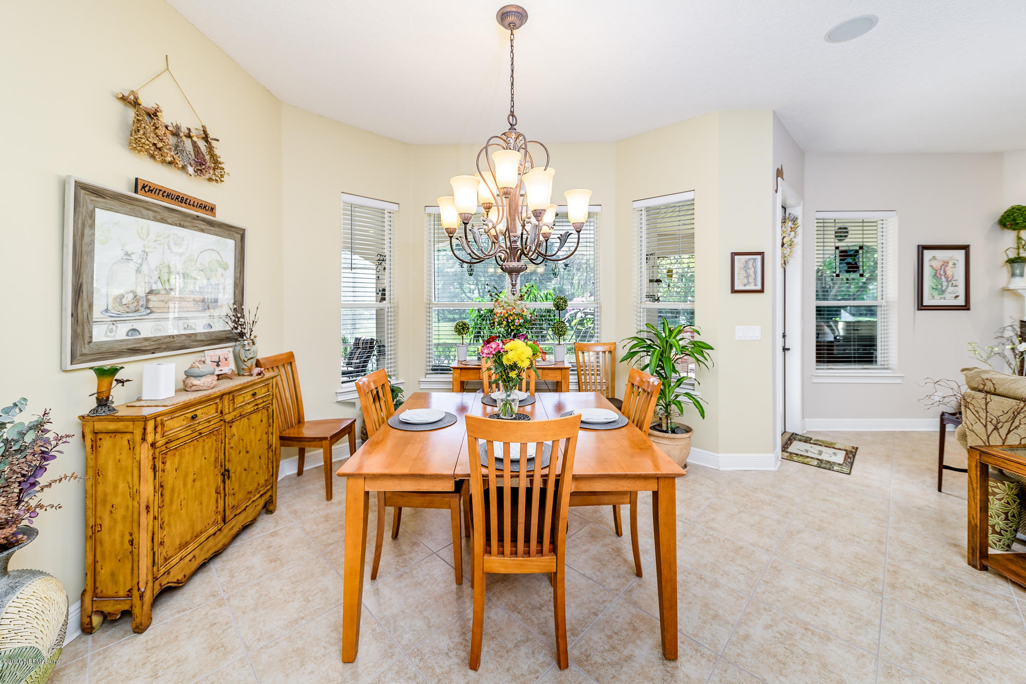 8313 Sheila Drive St. Augustine, FL 32092 - Photo 15 of 54 a view of a dining room with furniture window and wooden floor