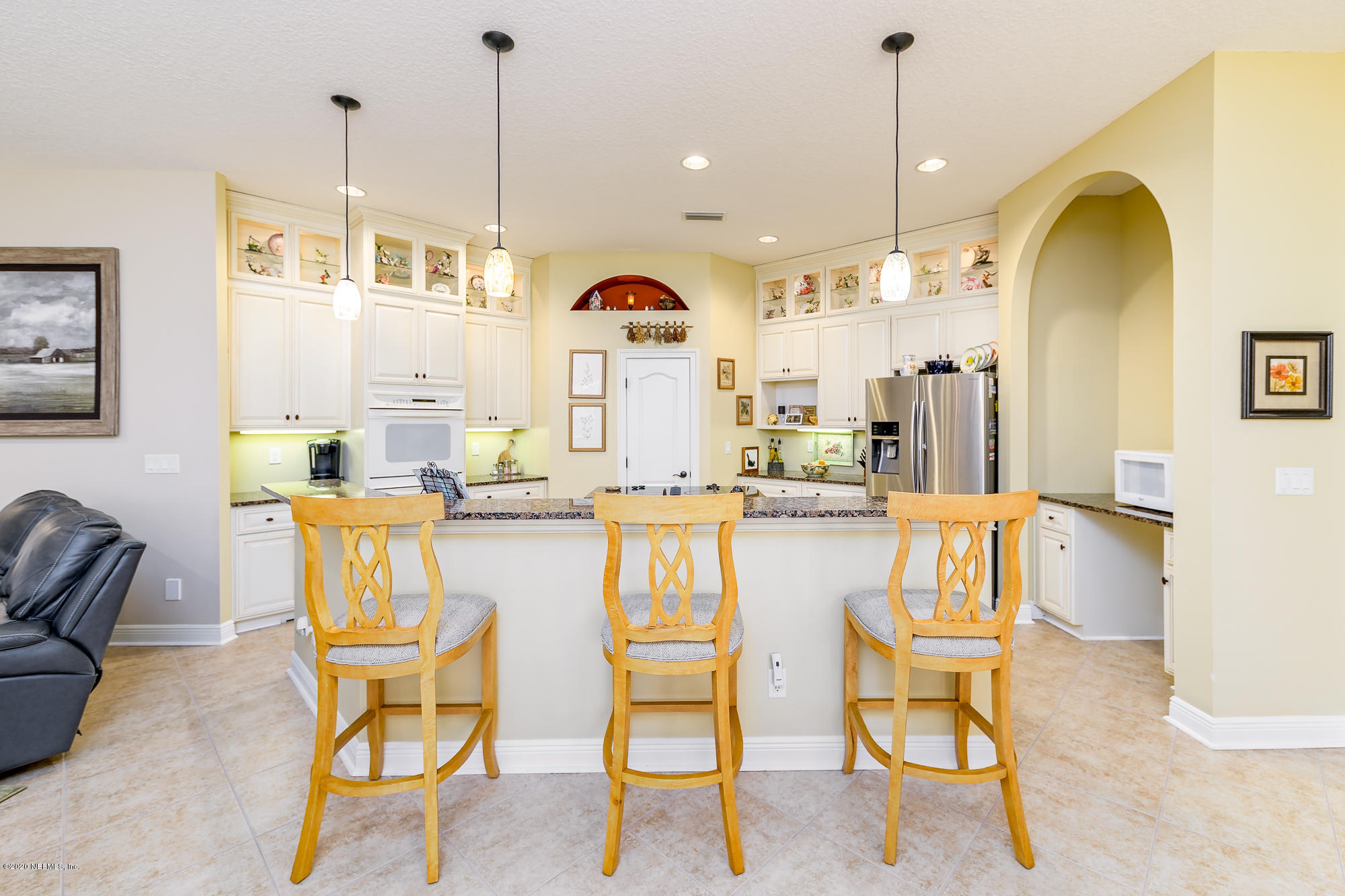 8313 Sheila Drive St. Augustine, FL 32092 - Photo 16 of 54 a dining hall with stainless steel appliances kitchen island granite countertop a table and chairs