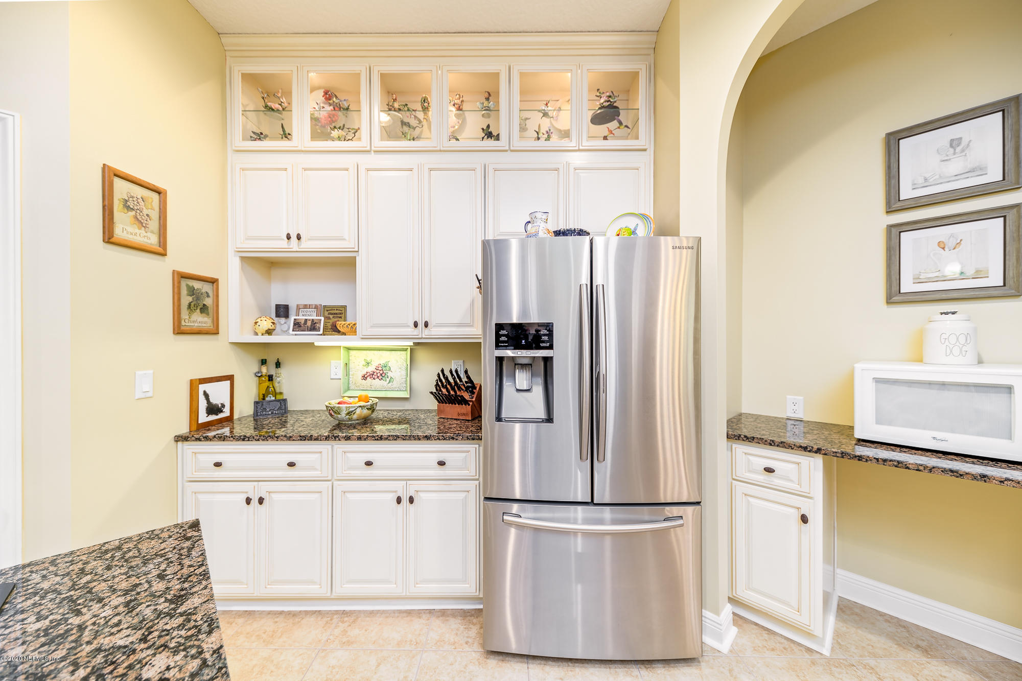 8313 Sheila Drive St. Augustine, FL 32092 - Photo 17 of 54 a kitchen with stainless steel appliances a refrigerator and cabinets