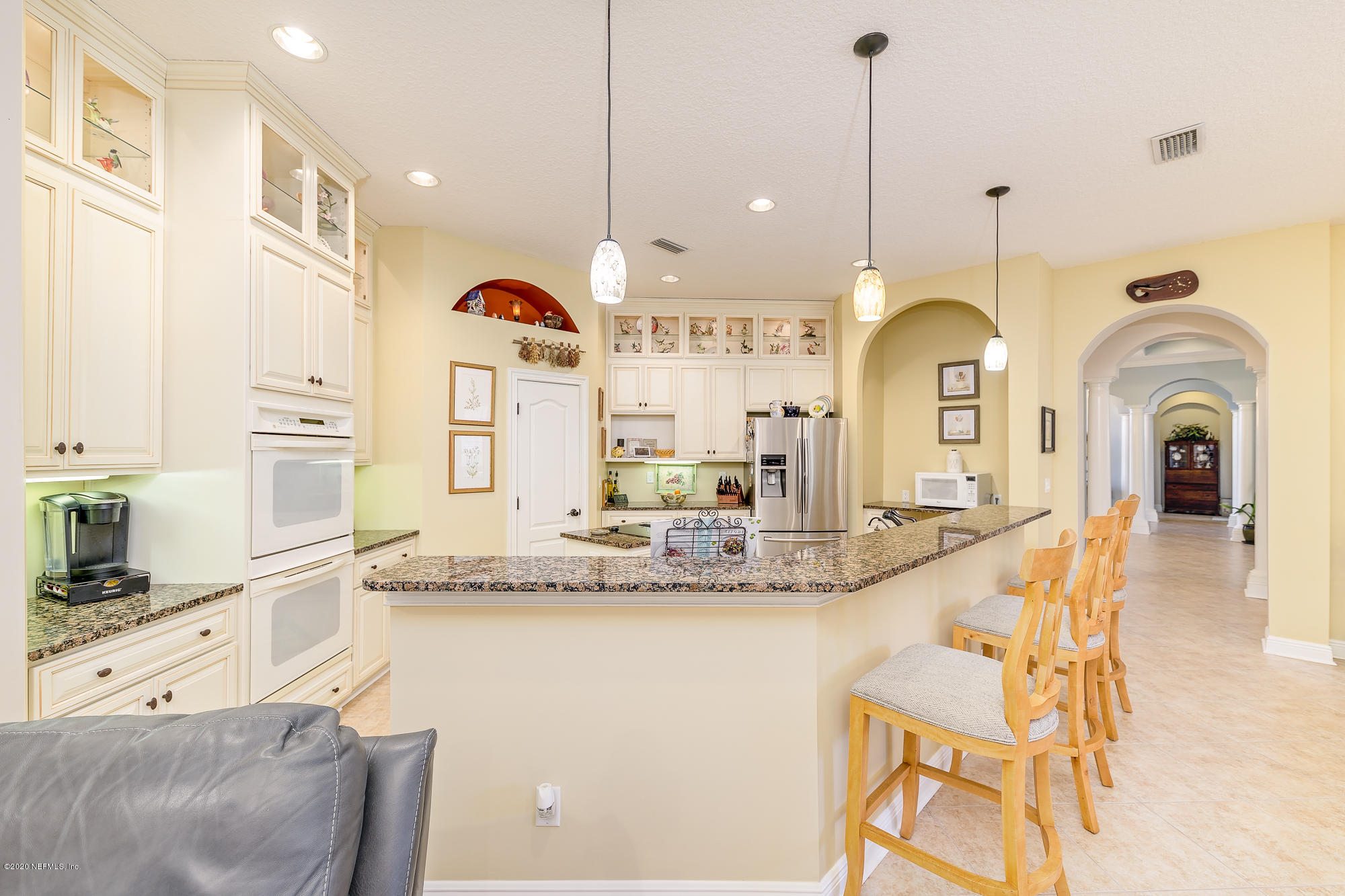 8313 Sheila Drive St. Augustine, FL 32092 - Photo 18 of 54 a view of a kitchen with kitchen island a sink and chandelier