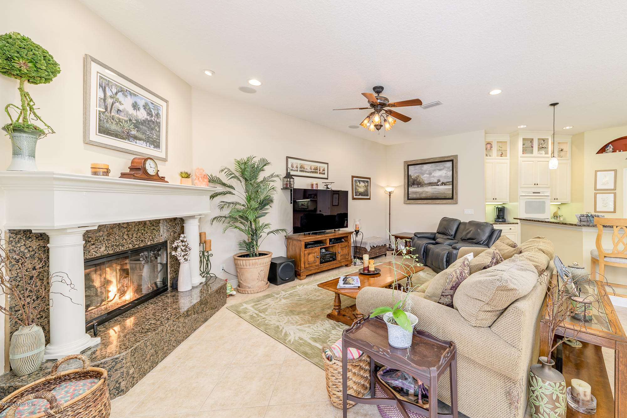8313 Sheila Drive St. Augustine, FL 32092 - Photo 21 of 54 a living room with furniture a fireplace and a flat screen tv