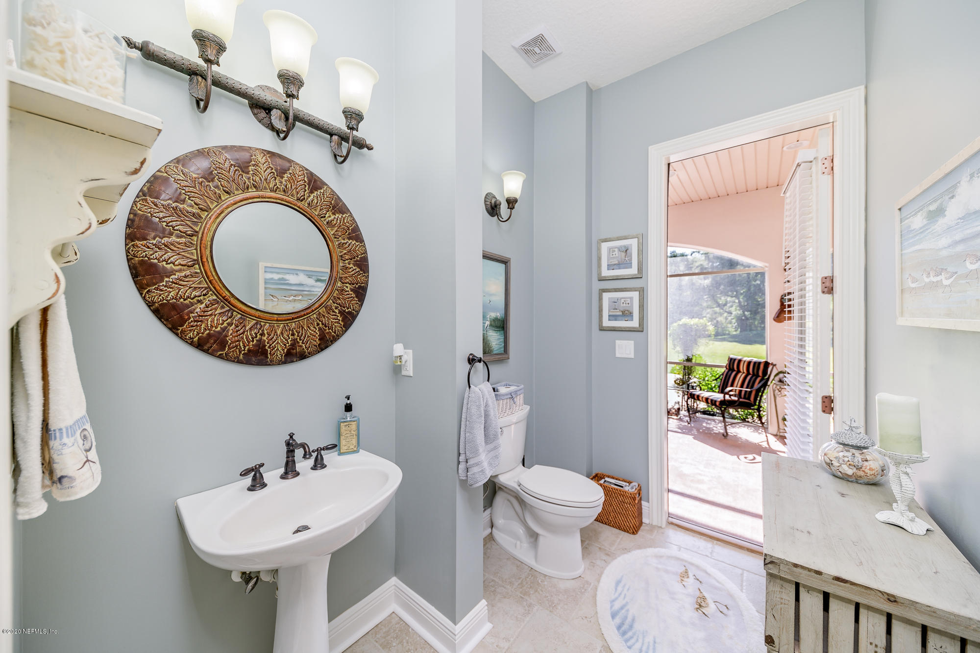8313 Sheila Drive St. Augustine, FL 32092 - Photo 22 of 54 a bathroom with a sink mirror toilet and shower