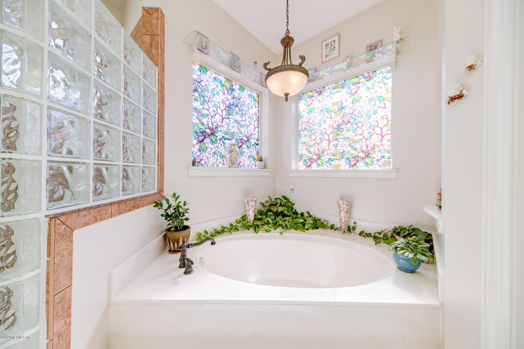 8313 Sheila Drive St. Augustine, FL 32092 - Photo 28 of 54 a white bath tub sitting in a bathroom next to a window