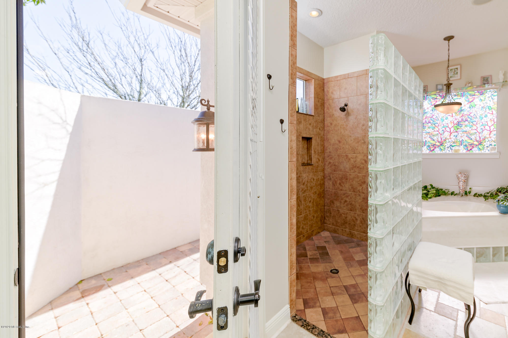 8313 Sheila Drive St. Augustine, FL 32092 - Photo 29 of 54 a bathroom with a bathtub and shower