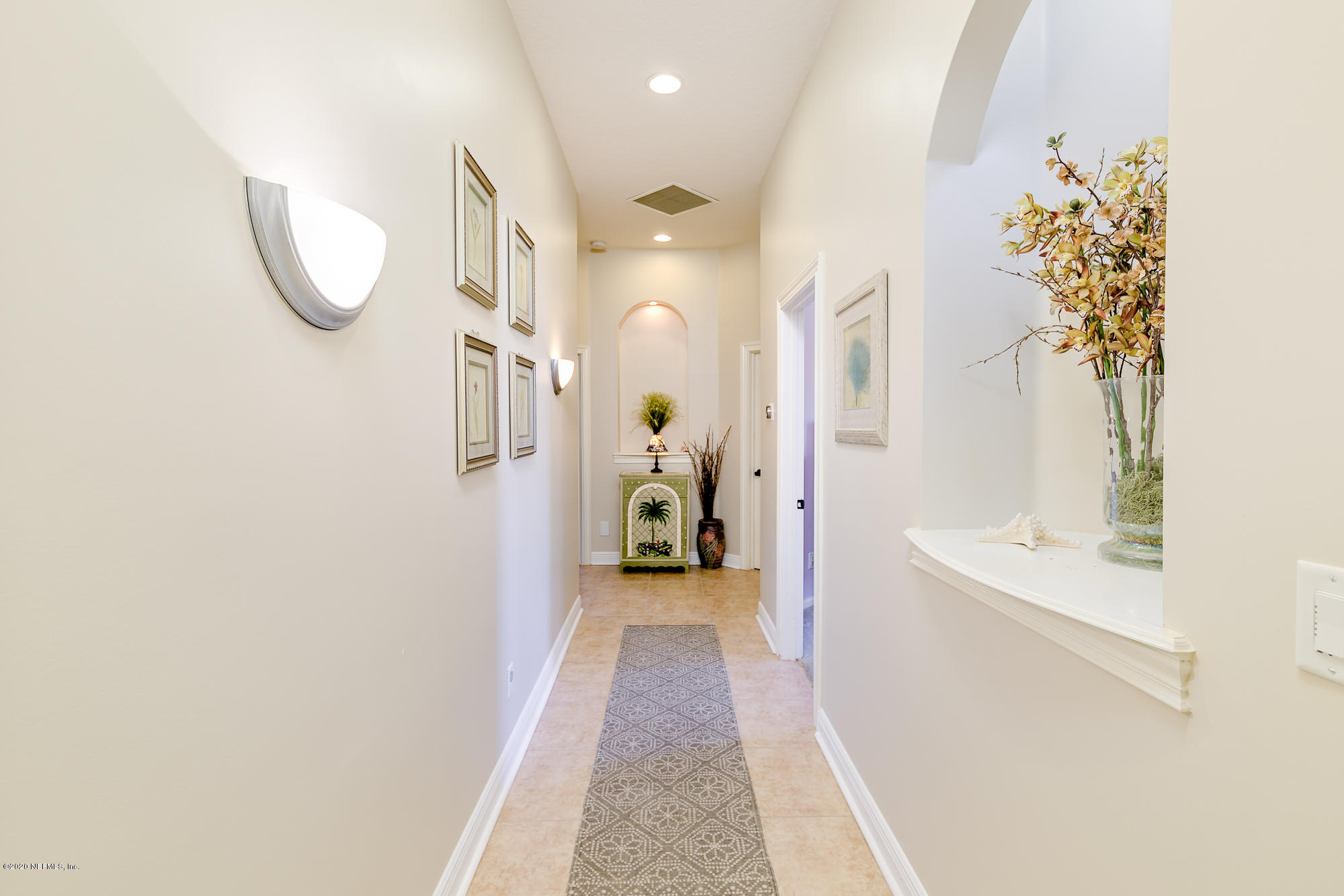 8313 Sheila Drive St. Augustine, FL 32092 - Photo 32 of 54 a view of a hallway with wooden floor and a bathroom