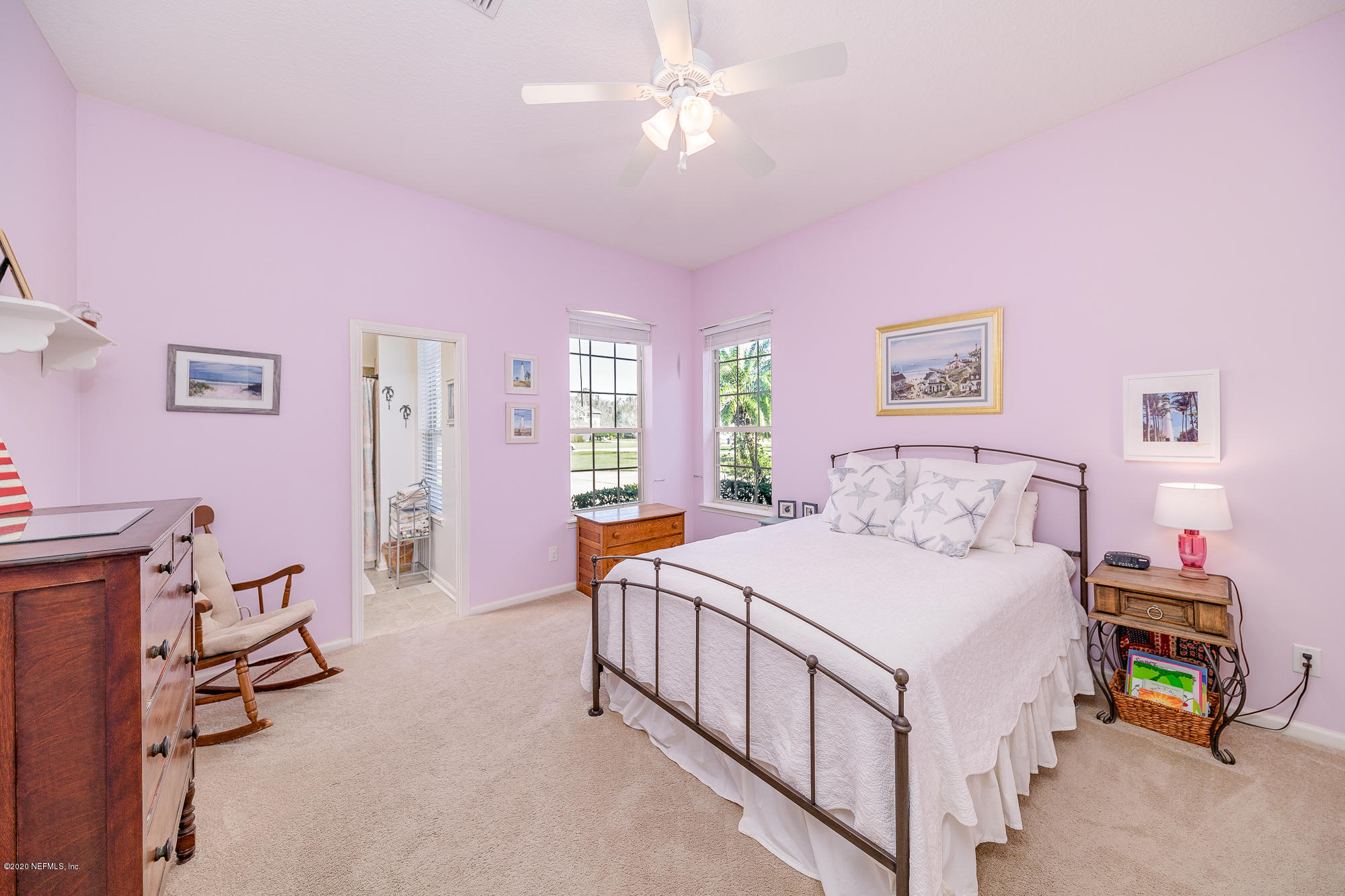 8313 Sheila Drive St. Augustine, FL 32092 - Photo 33 of 54 a bedroom with a bed and a chandelier