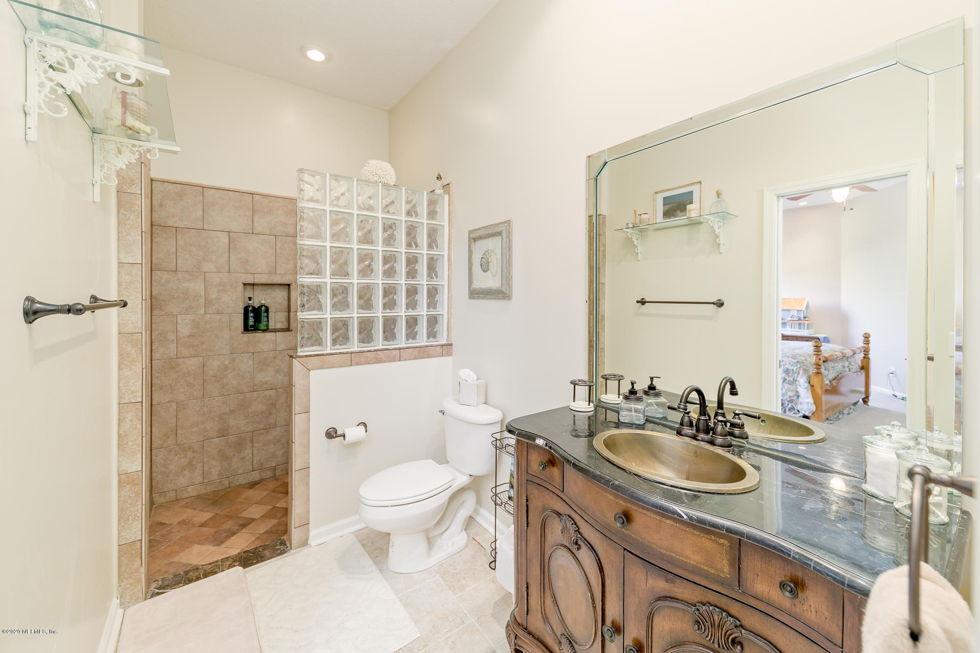8313 Sheila Drive St. Augustine, FL 32092 - Photo 36 of 54 a bathroom with a sink toilet a shower and a mirror