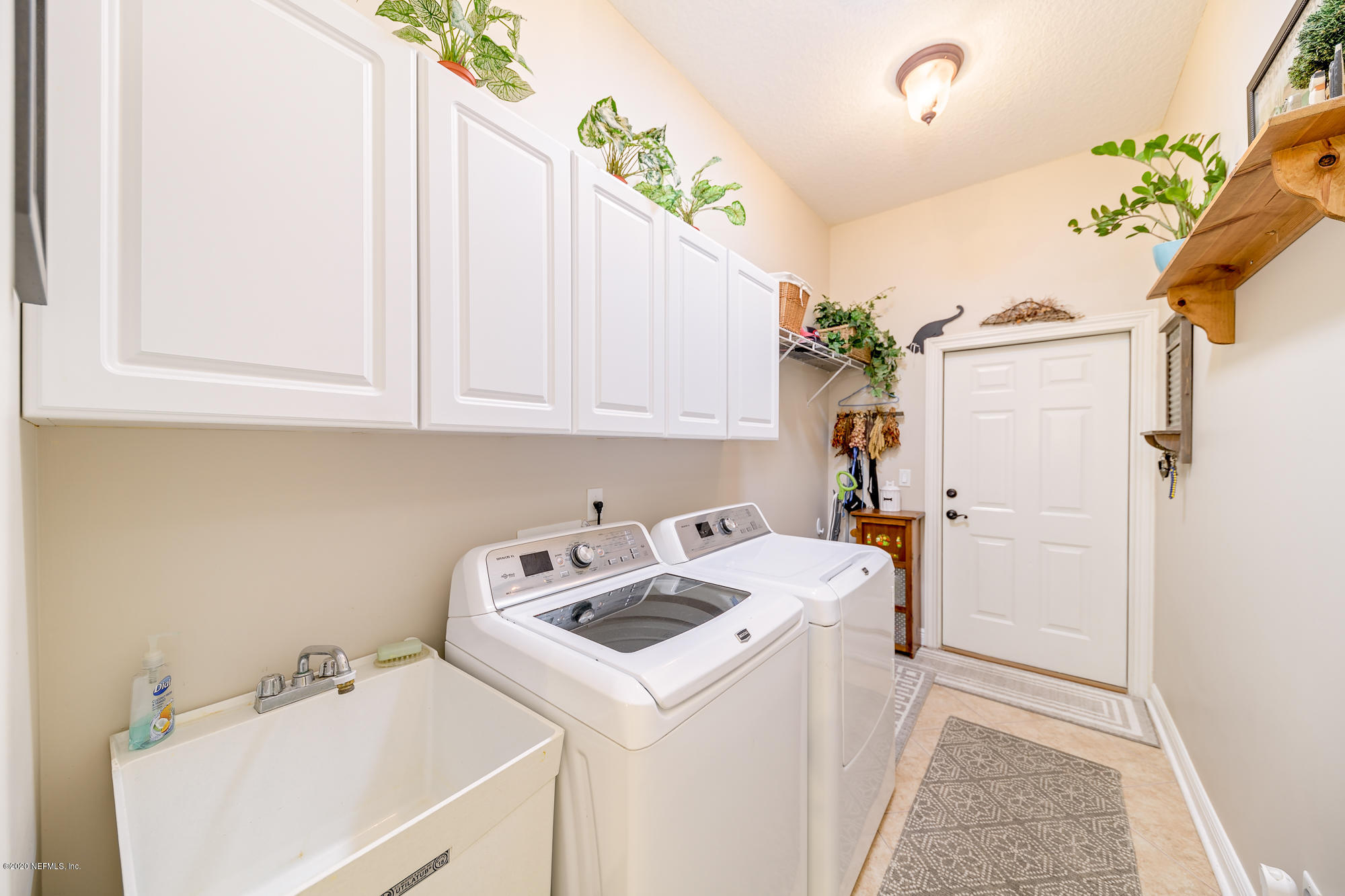 8313 Sheila Drive St. Augustine, FL 32092 - Photo 38 of 54 a view of bathroom with a sink and washer