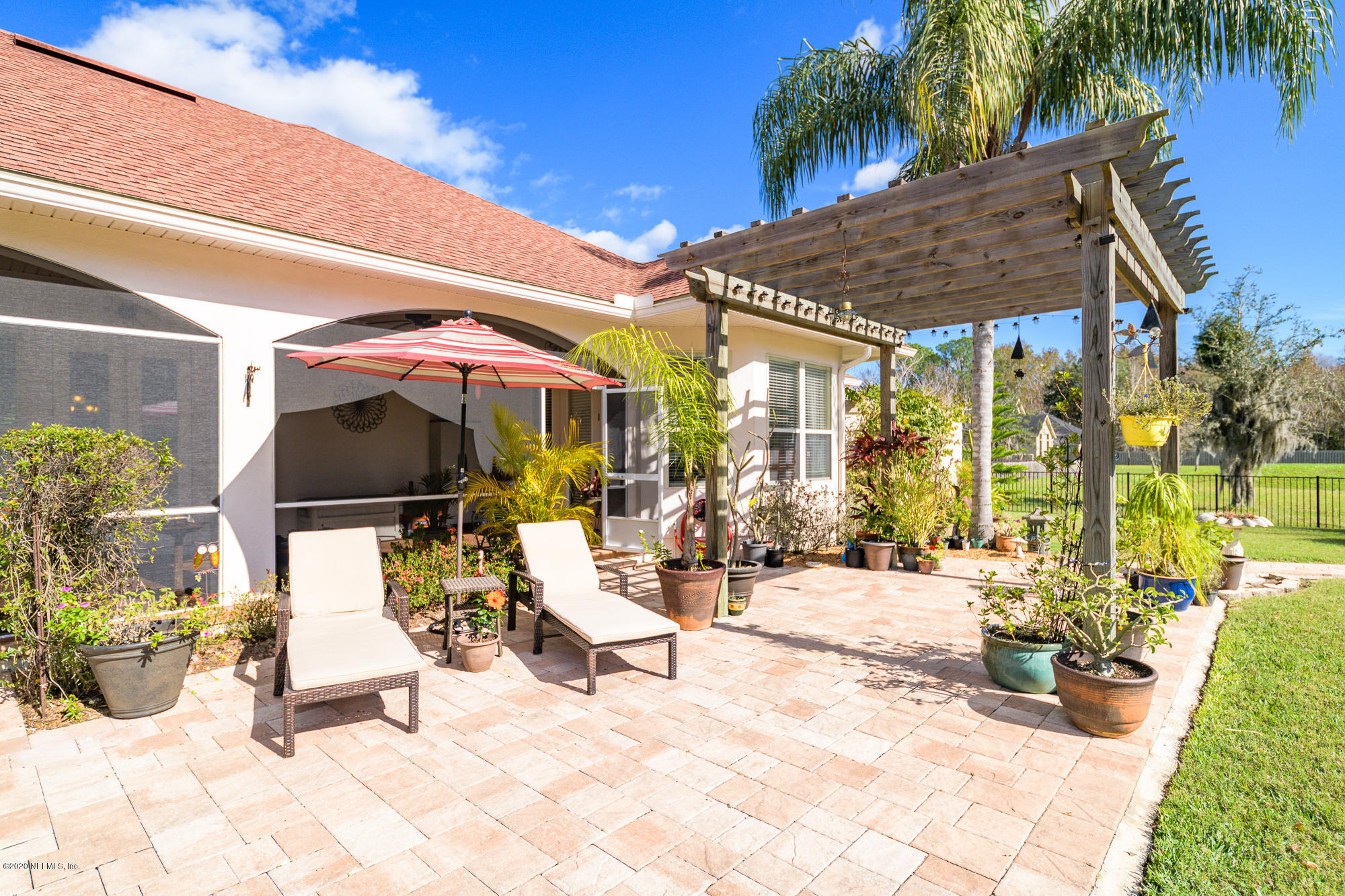 8313 Sheila Drive St. Augustine, FL 32092 - Photo 46 of 54 a building outdoor space with patio furniture and potted plants