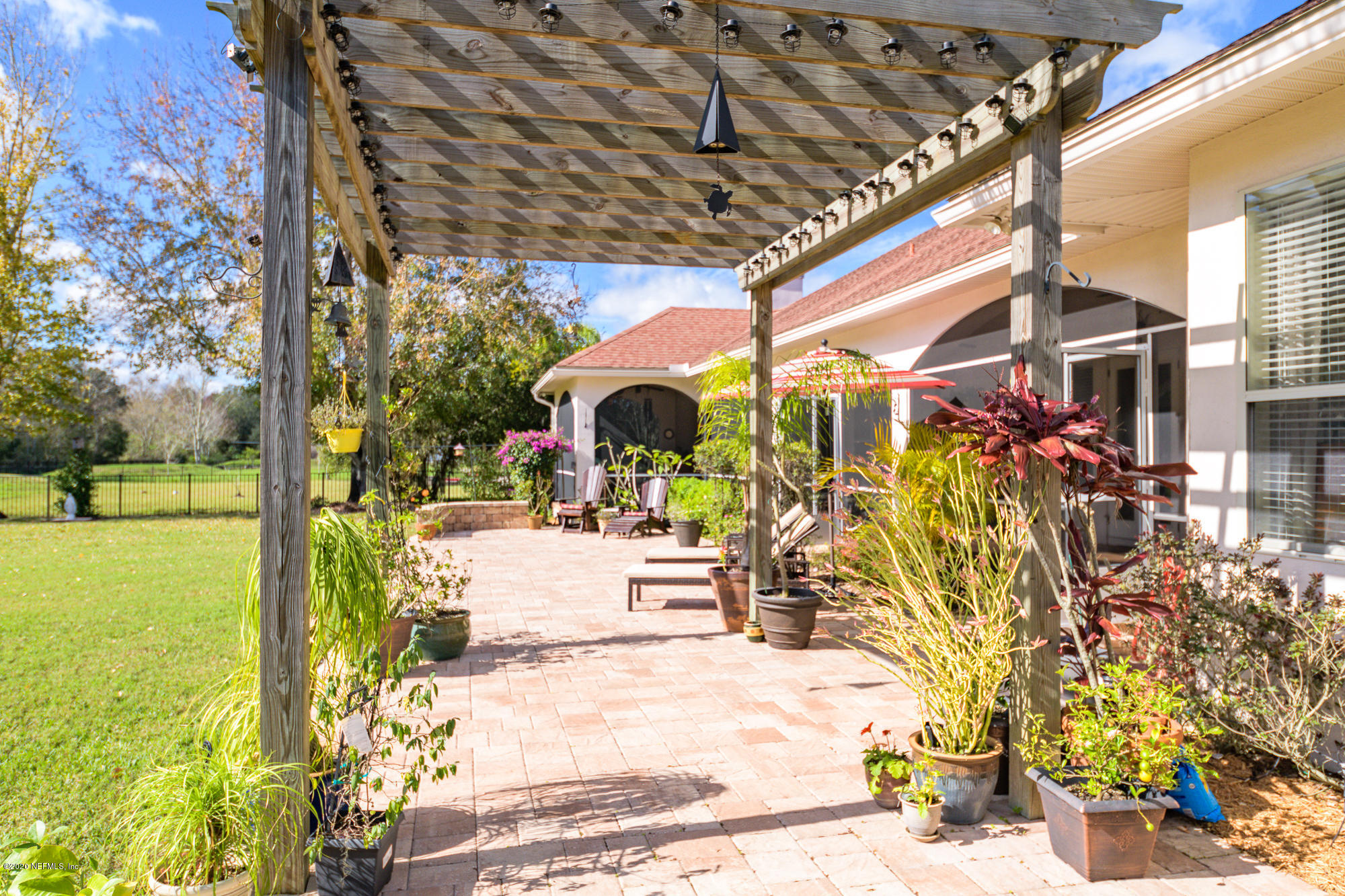 8313 Sheila Drive St. Augustine, FL 32092 - Photo 47 of 54 a view of a patio with table and chairs under an umbrella