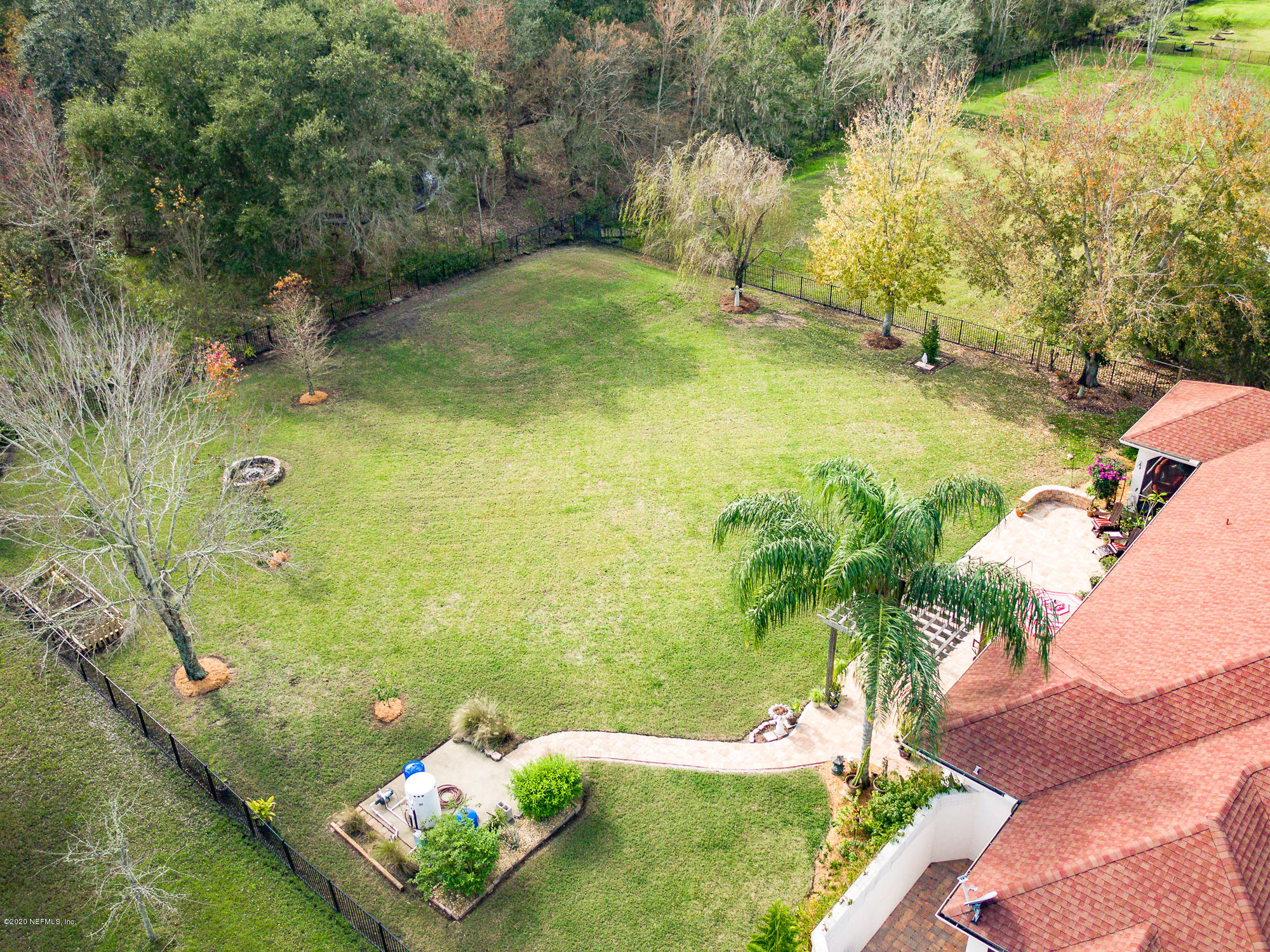 8313 Sheila Drive St. Augustine, FL 32092 - Photo 51 of 54 a blue swimming pool with lawn chairs and large trees