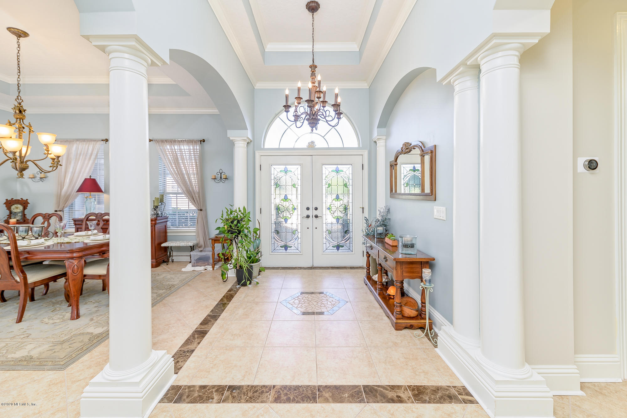 8313 Sheila Drive St. Augustine, FL 32092 - Photo 10 of 54 a hallway with beautiful frames and flower vase