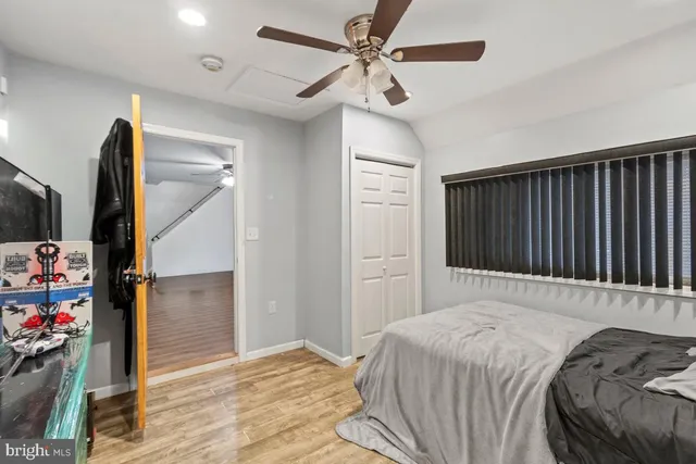 a bedroom with a bed closet and a flat tv screen