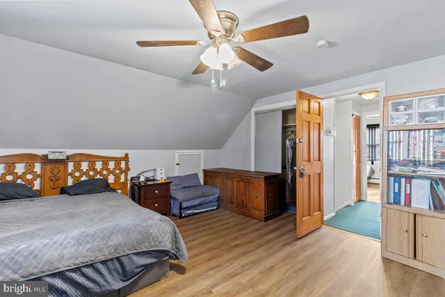 a bedroom with bed and a book shelf