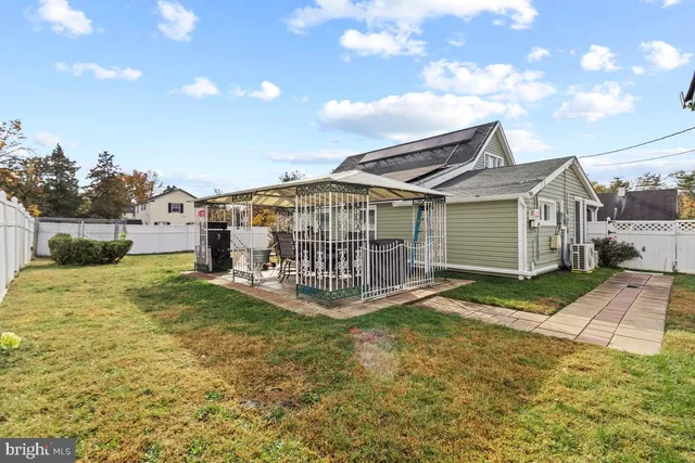 a view of a house with a yard and sitting area