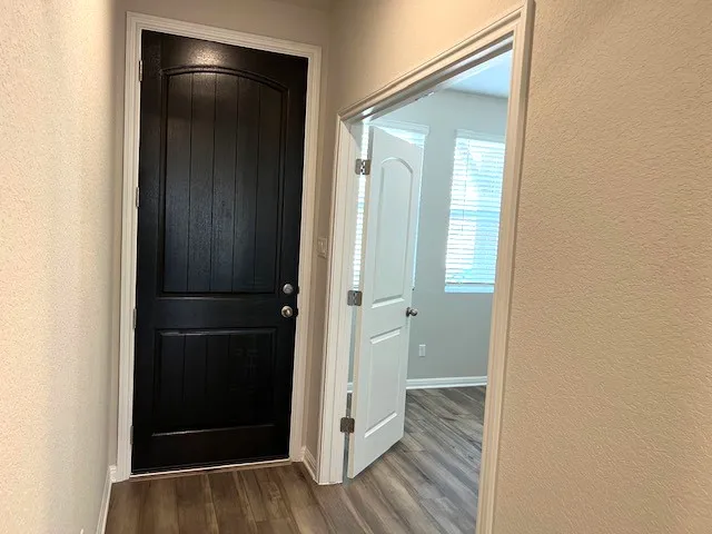 a view of hallway with wooden floor