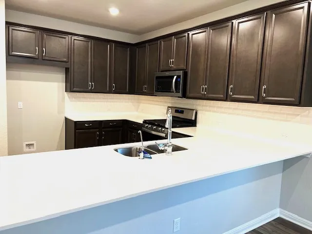 a kitchen with a sink and cabinets