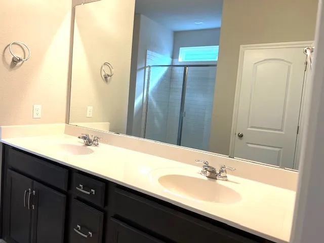 a view of bathroom with a shower and a sink