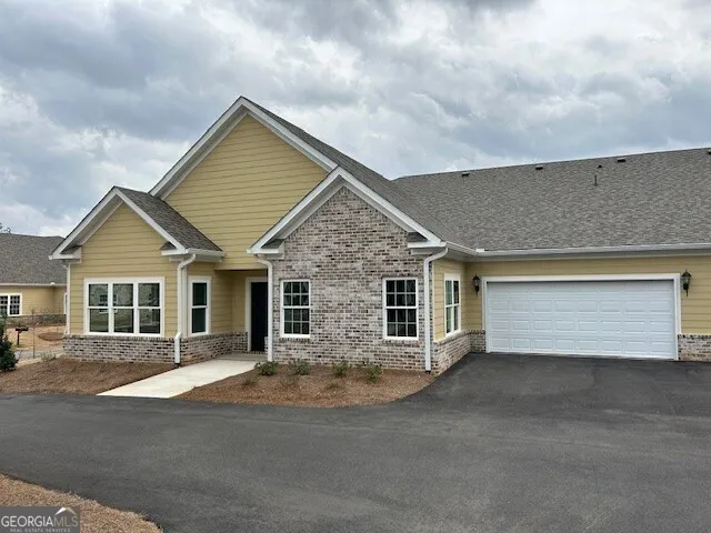 a view of house with outdoor space and large windows