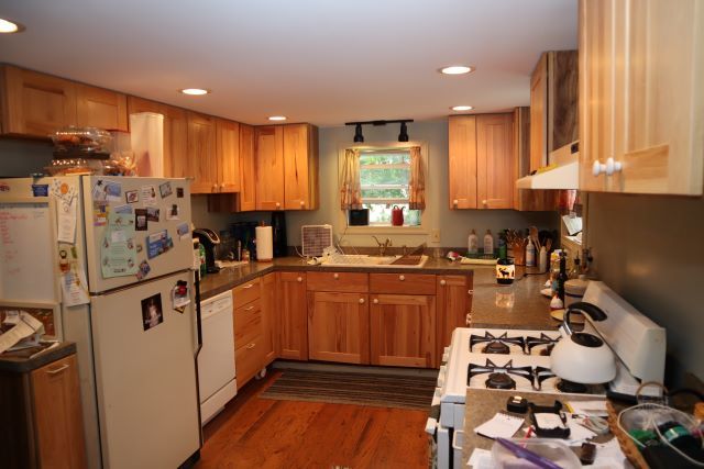 20590 Moline Road Lyndon, IL 61261 - Photo 8 of 11 a kitchen with stainless steel appliances granite countertop a refrigerator sink and wooden cabinets