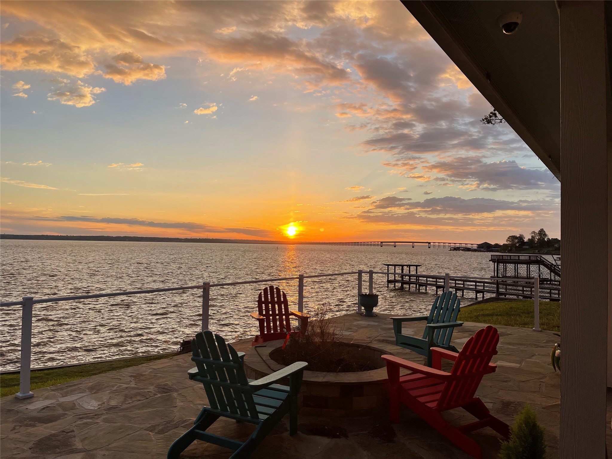 Breathtaking sunset views from the waterfront deck create the perfect setting for entertaining, relaxing, and enjoying lake life at its finest.
