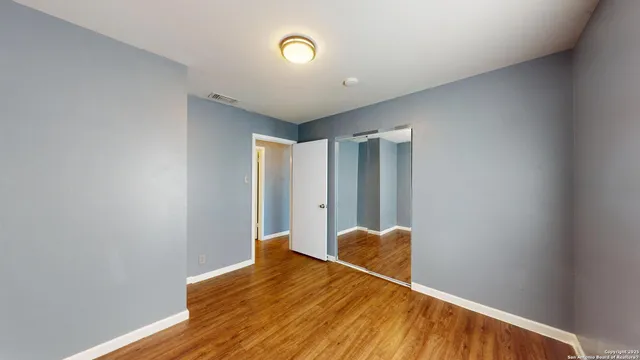 a view of room with wooden floor