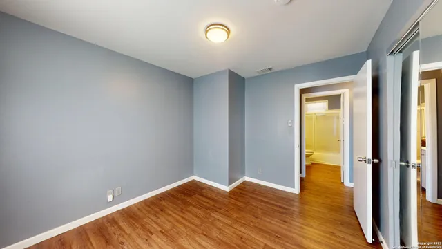 a view of room with wooden floor