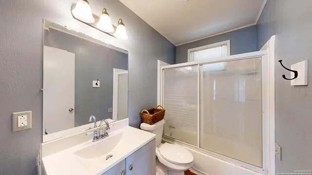 a bathroom with a sink toilet and shower