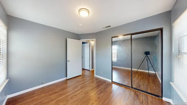 a view of hallway with wooden floor