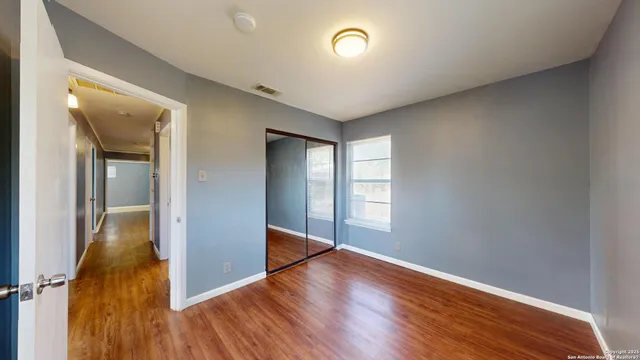 wooden floor in an empty room with a window