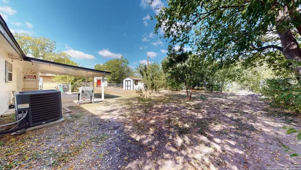 a view of a yard with a tree
