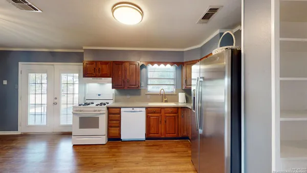 a kitchen with stainless steel appliances granite countertop a stove a refrigerator and a sink