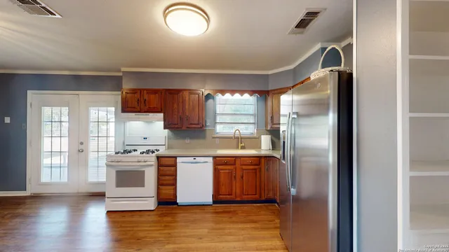 a kitchen with stainless steel appliances granite countertop a stove a refrigerator and a sink