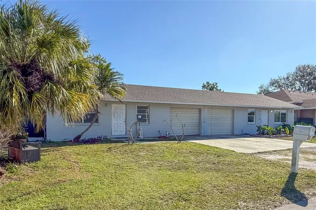 a front view of house with yard and trees