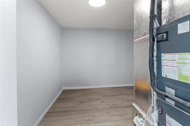 a view of an empty room and wooden floor