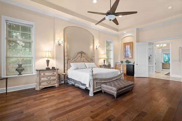 a bedroom with furniture and a large window