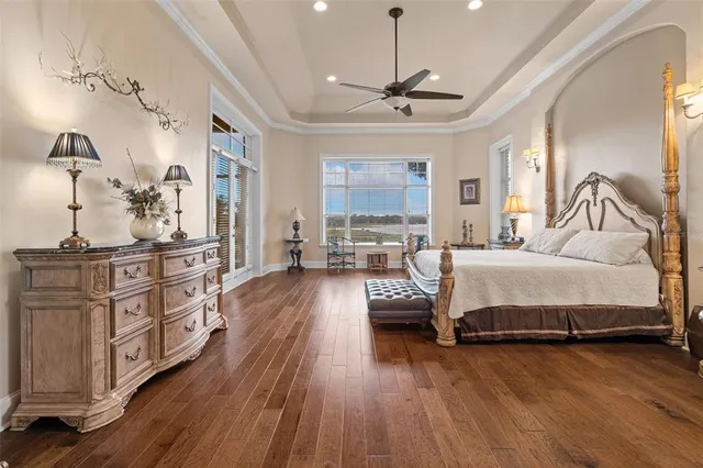 a spacious bathroom with a granite countertop sink a mirror and a shower