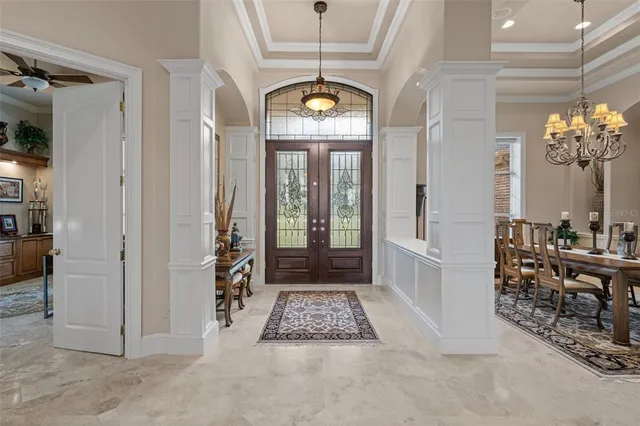 a view of a hallway with furniture and windows