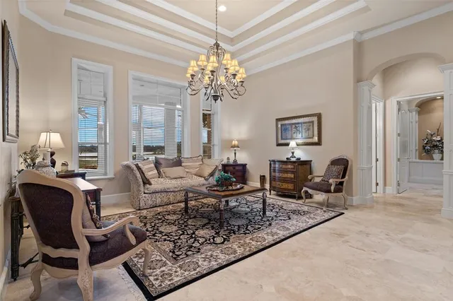 a living room with furniture and a chandelier